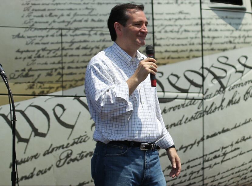 Senate candidate Ted Cruz speaks at a tea party rally in the parking lot of Park Central...