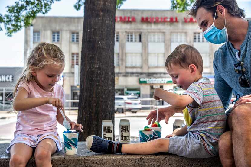 From left, siblings Victoria West, 4, and Preston, 3, enjoy rainbow snow cones from NOLA...