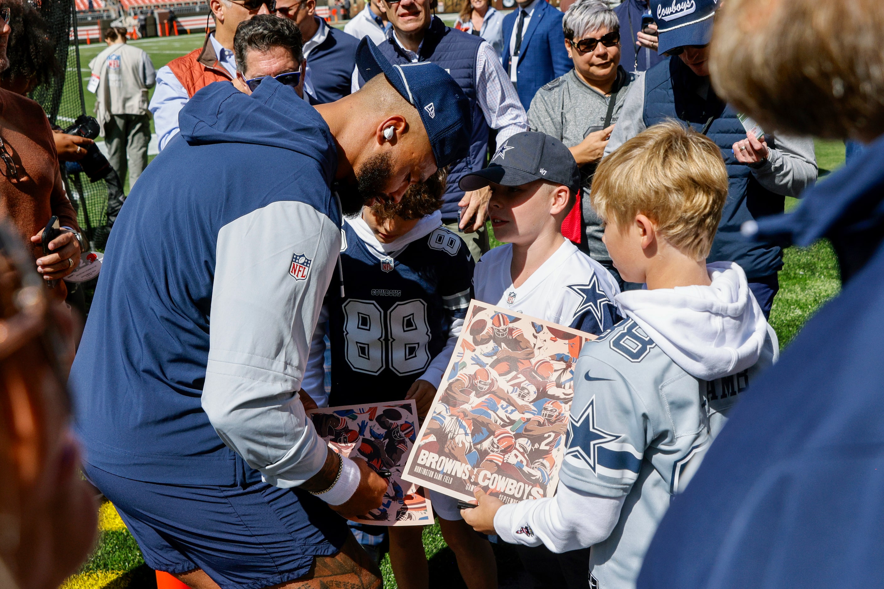 Dallas Cowboys quarterback Dak Prescott signs autographs for young fans before the first...