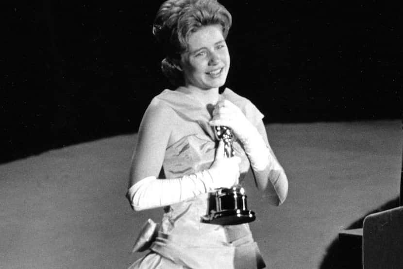 FILE - In this April 8, 1963 file photo, actress Patty Duke, 16, accepts the Oscar as best...