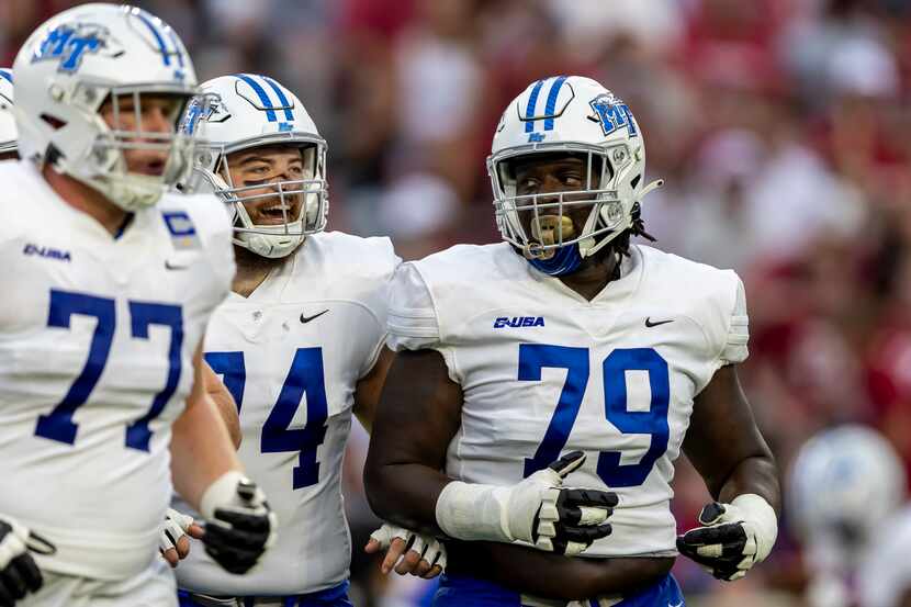 Middle Tennessee offensive linemen Ethan Ellis (74) and Sterling Porcher (79) take the field...