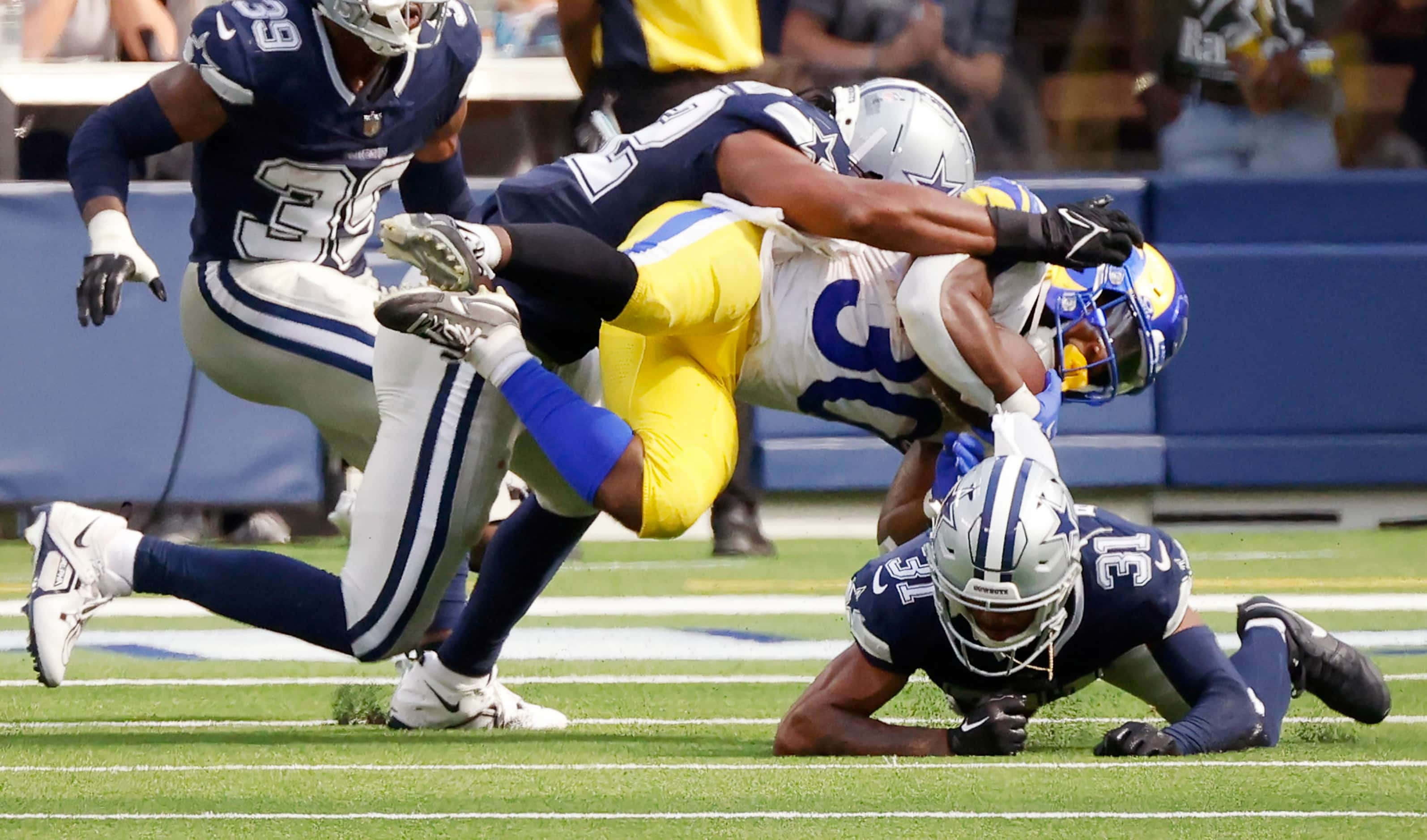 Dallas Cowboys cornerback Josh Butler (31) goes low to stop Los Angeles Rams running back...