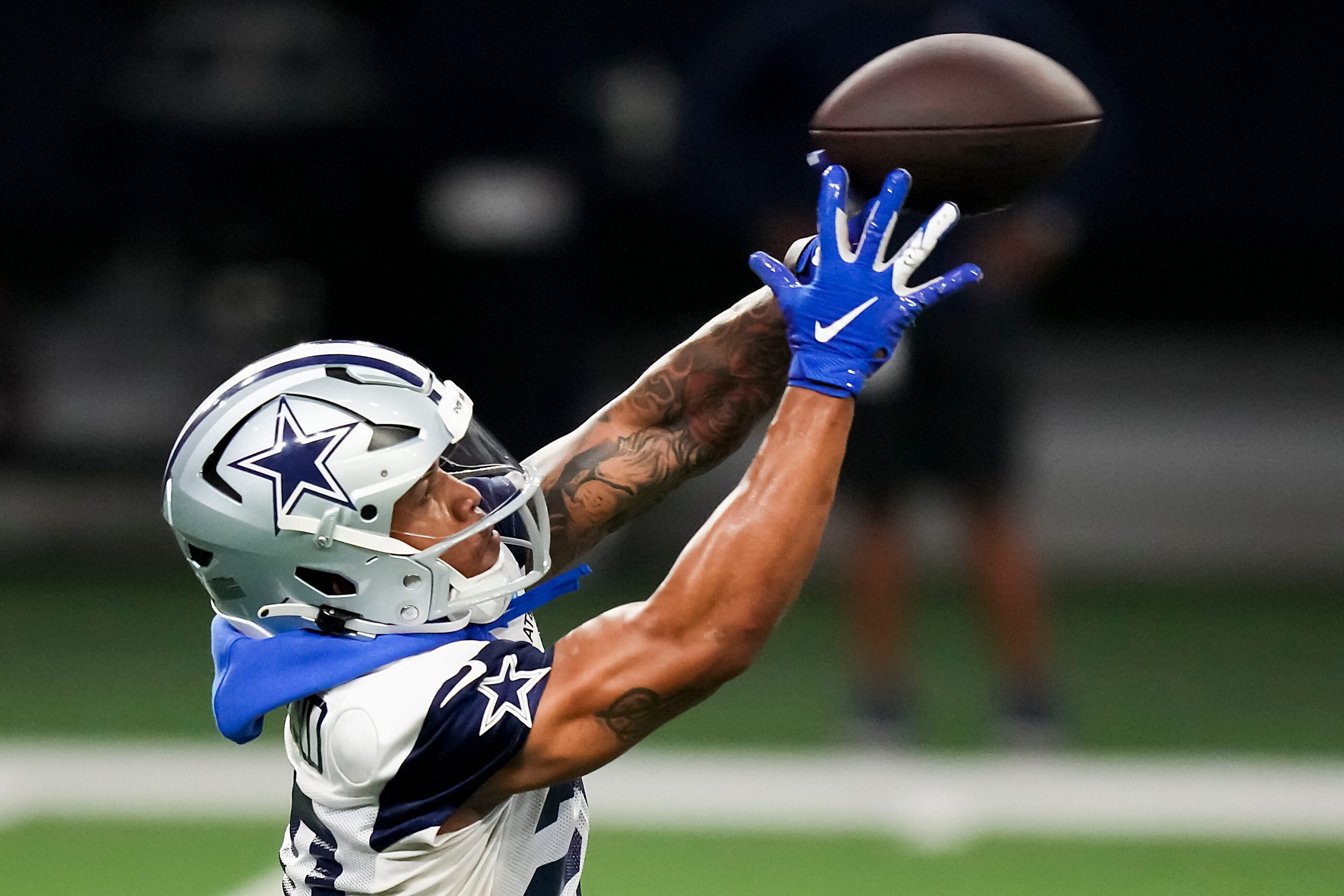 Dallas Cowboys running back Tony Pollard catches a pass during the OTA team's practice at...