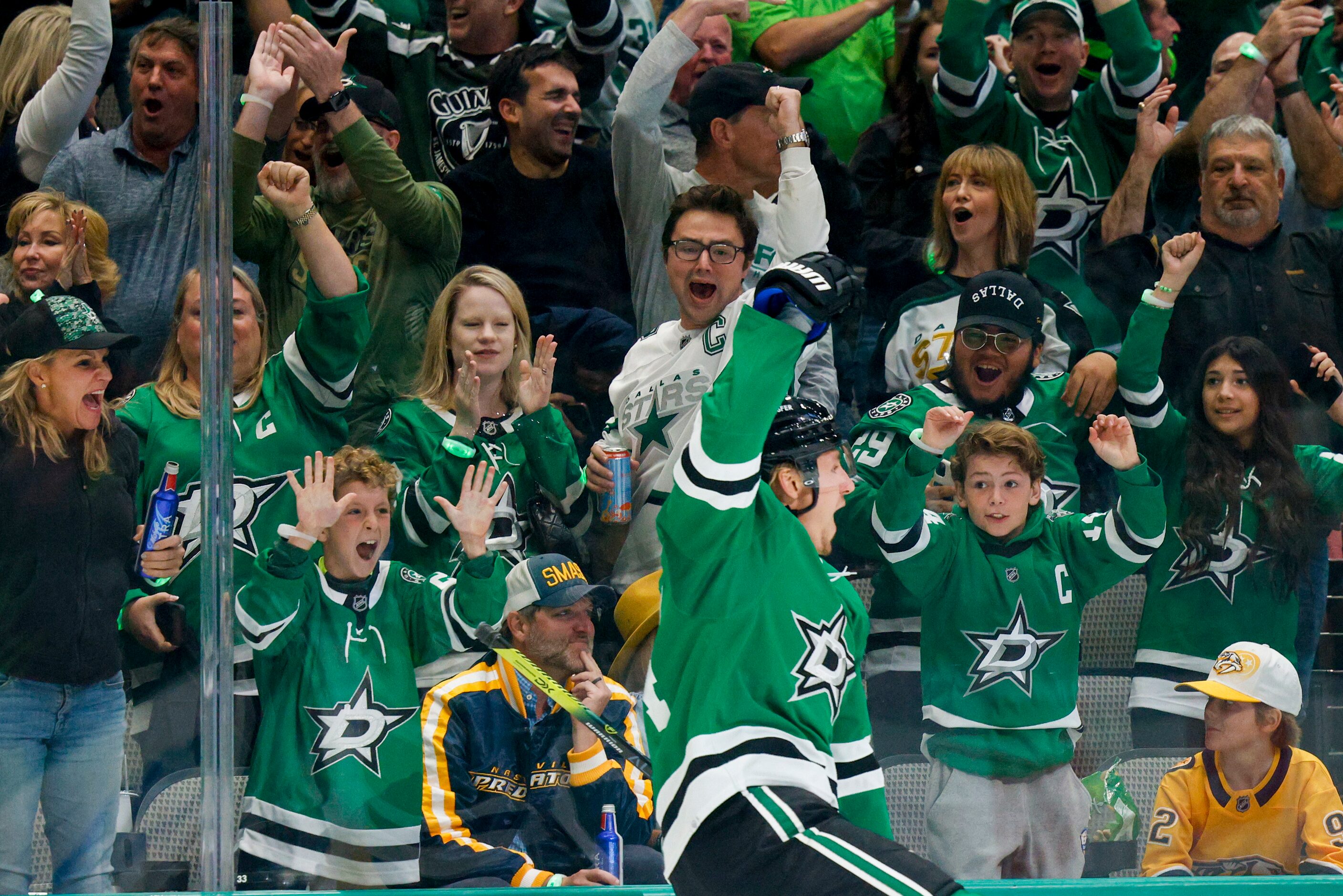 Fans celebrate a goal with Dallas Stars center Roope Hintz (24) during the first period of...