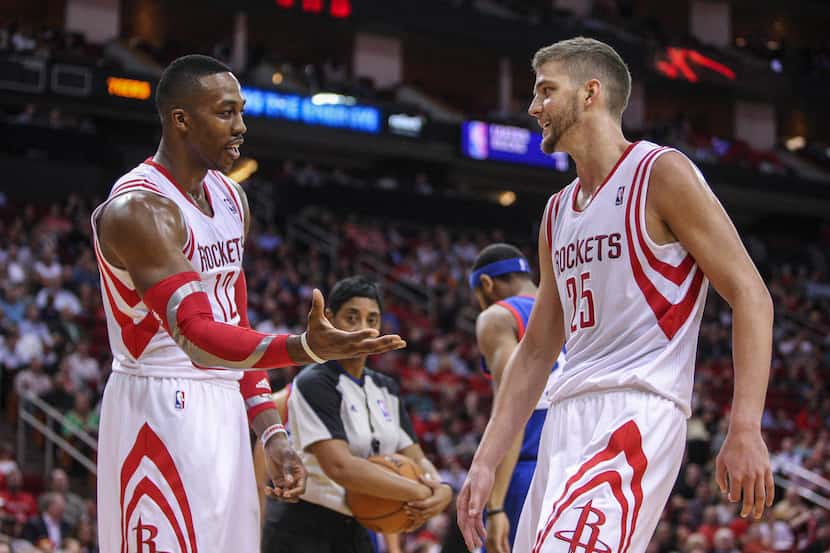 Houston Rockets center Dwight Howard (12) and forward Chandler Parsons (25) react after a...