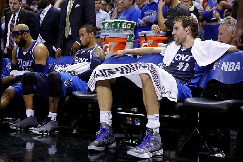 Dallas Mavericks forward Dirk Nowitzki (41) wasn't happy as he came to sit down during a...