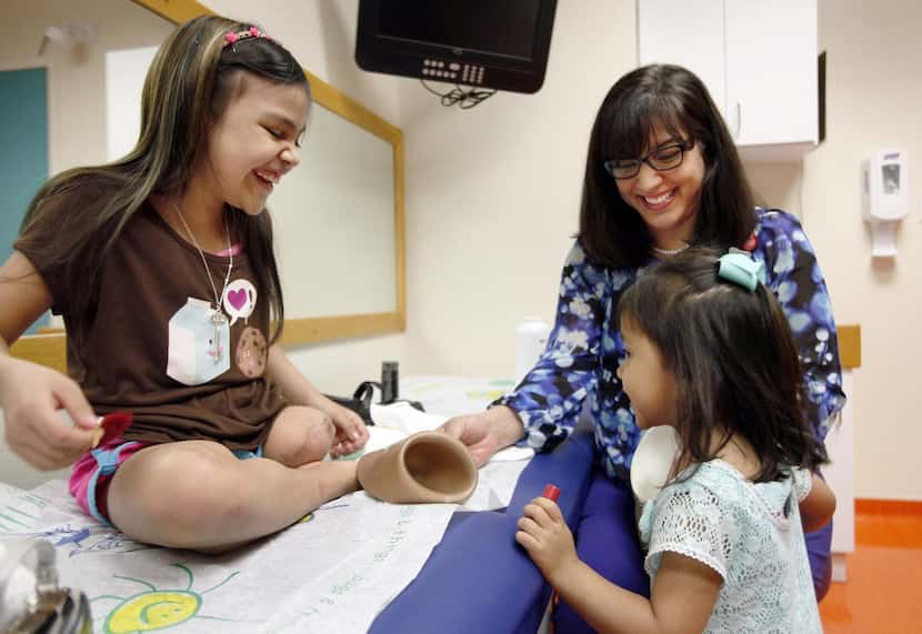 
Crystal Moreno (left), with her sister Jasmine, 3, got adjustments to her new prosthetic...