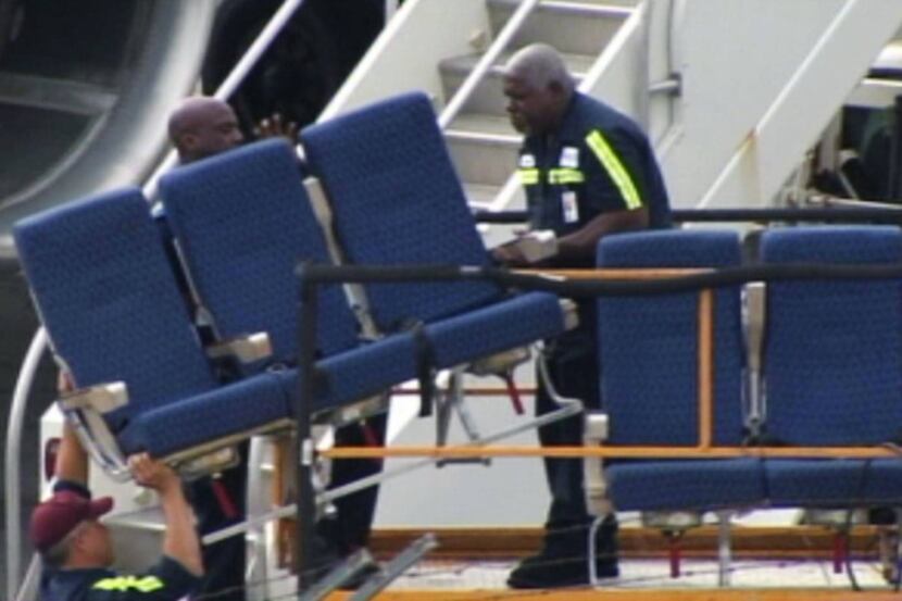 Crews remove seats from a Boeing 757 as part of a cabin refurbishment at Logan International...