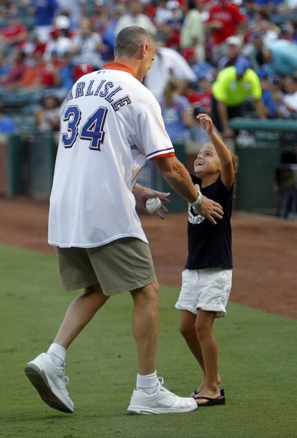 Carlisle hugs his daughter after throwing the first pitch before a Rangers game on August...
