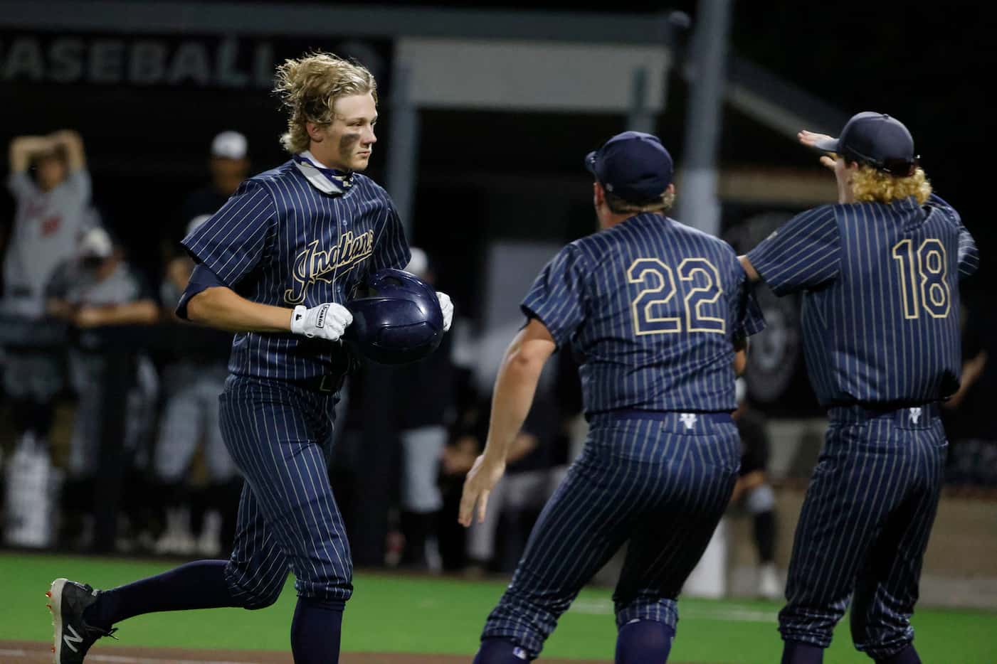 Keller’s Ty Zahradnik (27), left,  is congratulated by teammates after hitting a single...