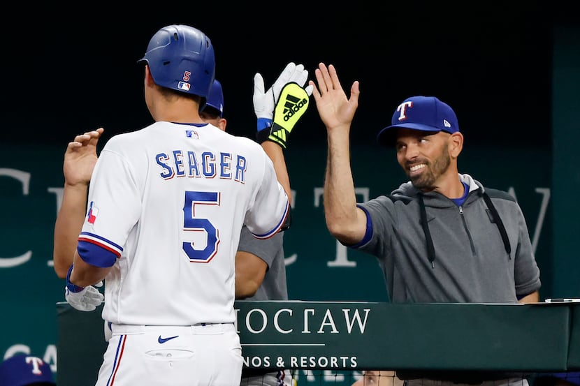 Texas Rangers batter Corey Seager (5) is congratulated on his two-run homer by manager Chris...