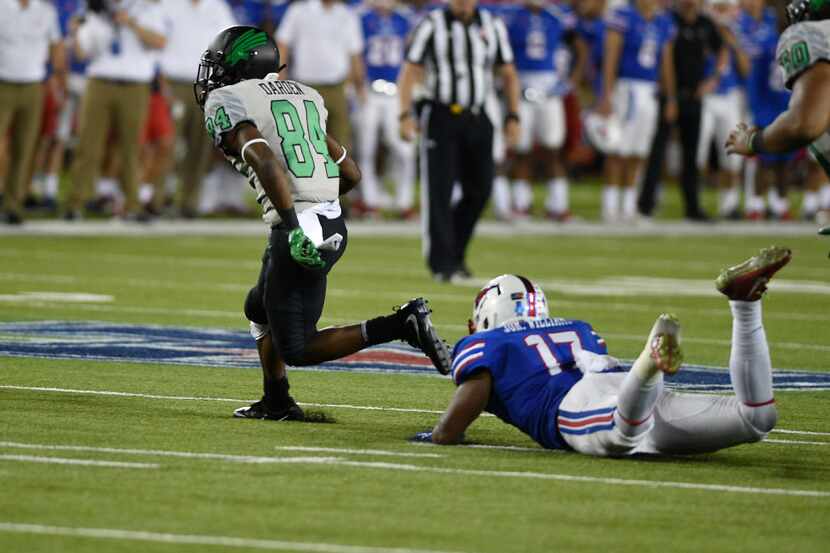 Caption
North Texas freshman wide receiver Jaelon Darden (84) escapes a tackle from Southern...