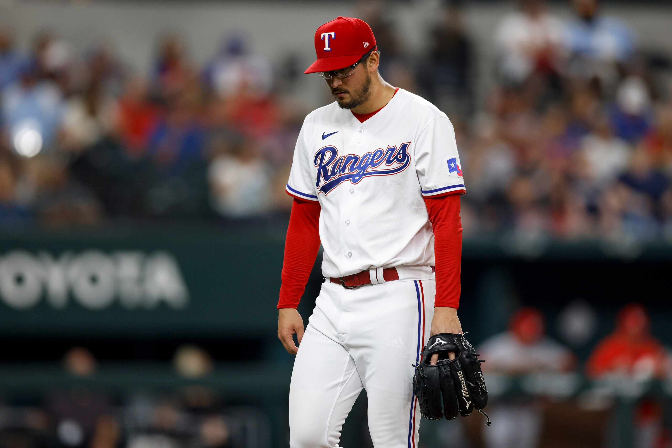 Texas Rangers relief pitcher Dane Dunning (33) hangs his head after giving up a home run in...