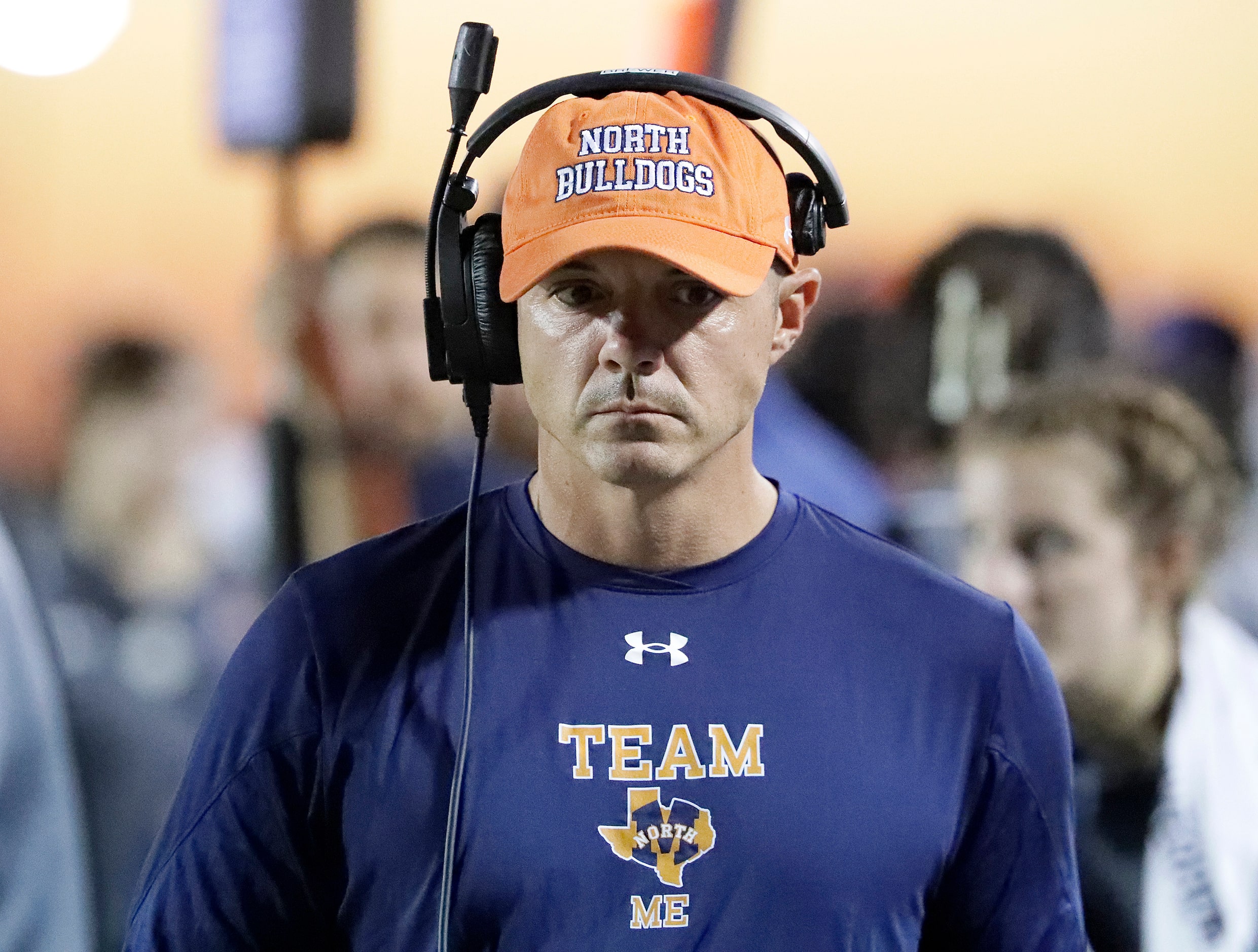 McKinney North High School head coach Kendall Brewer listens to his headset during the first...