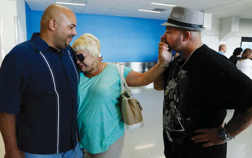 Anthony Wiggs (left) and Raymond Ramirez meet their biological mother, Elsie Ramirez, for...