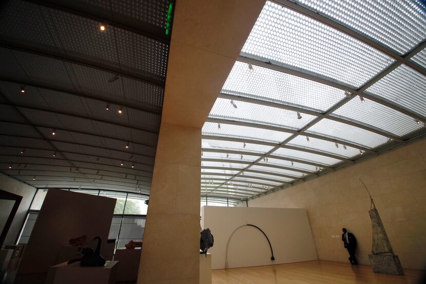A view of two galleries, the one on the left is covered with screens to protect the exhibit,...