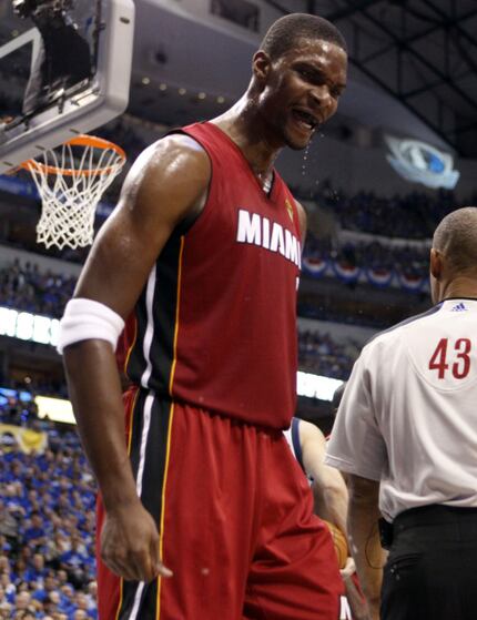 Miami Heat power forward Chris Bosh (1) reacts to dunking against the Dallas Mavericks in...