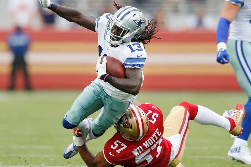 Dallas Cowboys wide receiver Lucky Whitehead (13) is tripped up by San Francisco 49ers...