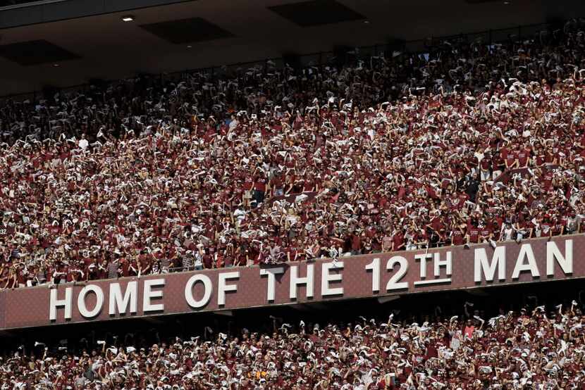 Texas A&M fans cheer during the first quarter of an NCAA college football game against the...
