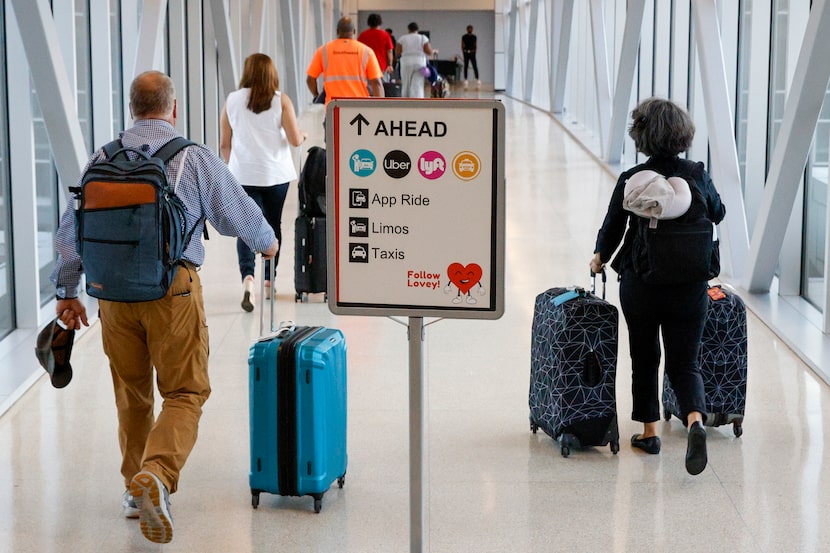 A sign directs travelers through a skybridge to Garage B for the new pickup location for...