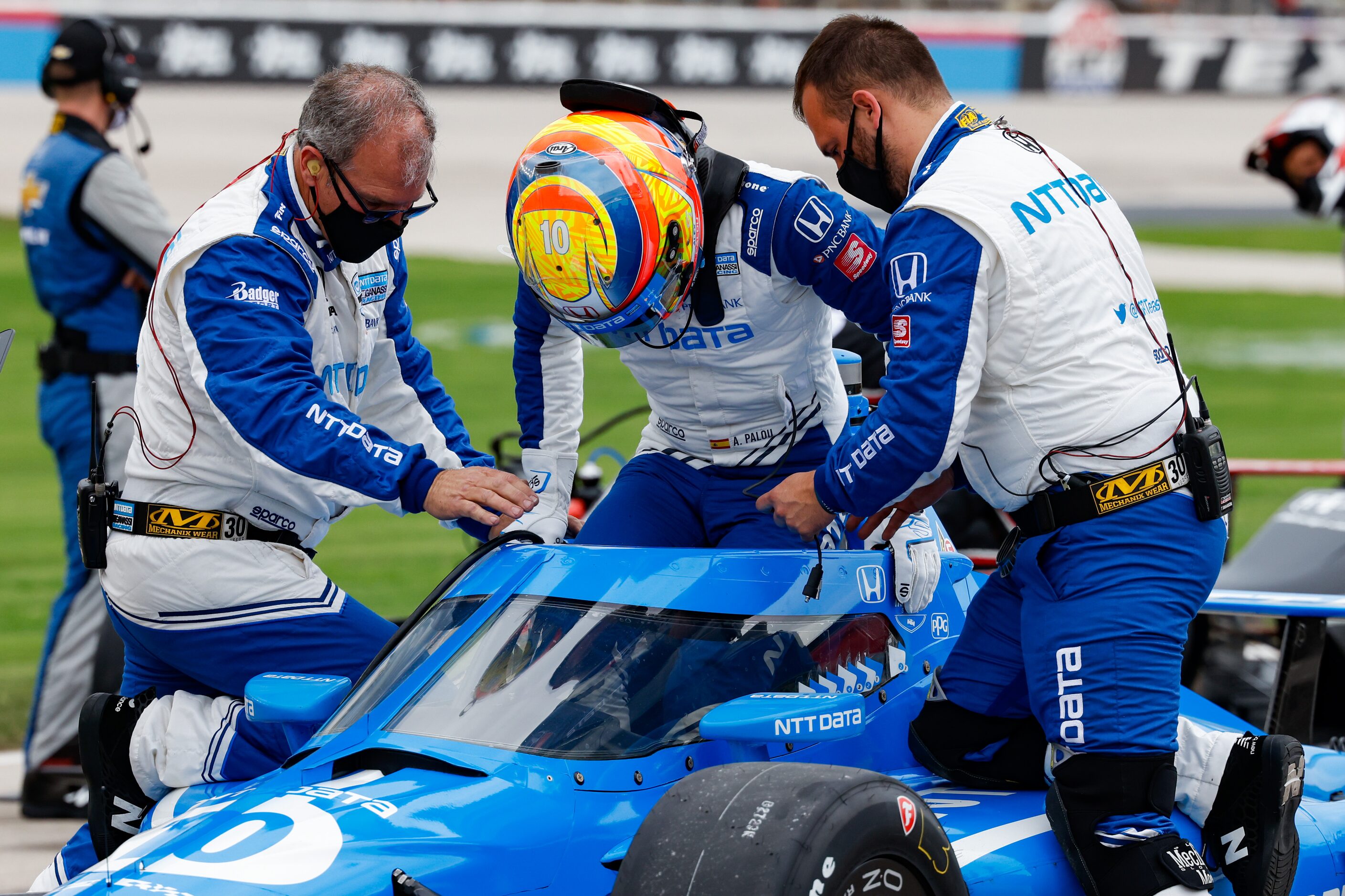 Alex Palou (#10) is helped into his car before the start of the IndyCar Genesys 300 at Texas...