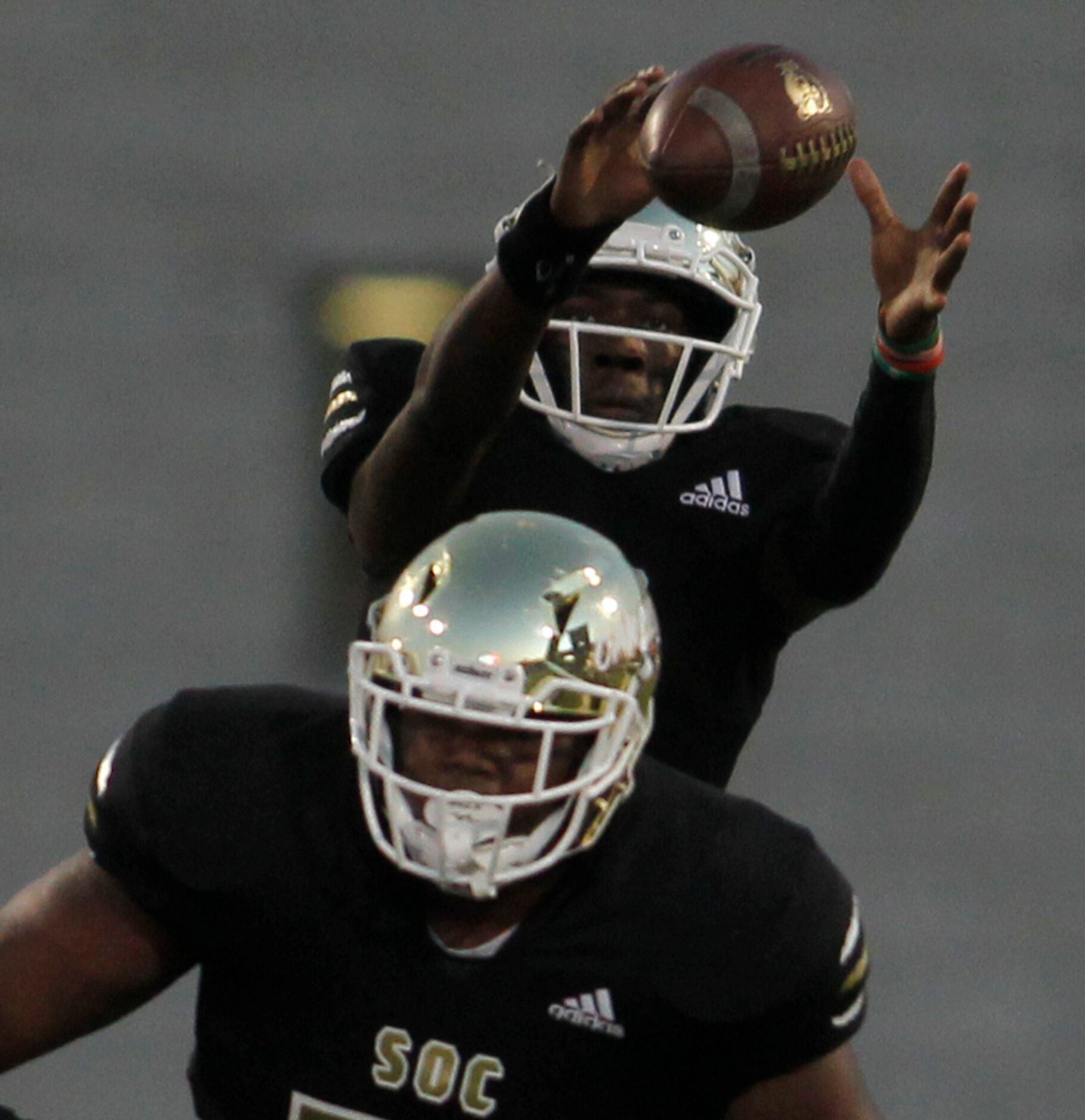 South Oak Cliff quarterback Kevin Henry-Jennings (8) leaps to pull down a high snap during...