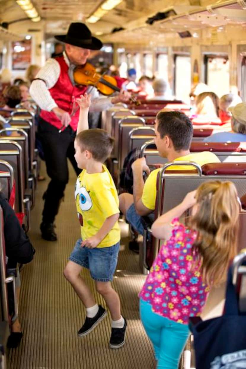 
This photo provided by Grand Canyon Railway shows a performer playing violin onboard the...