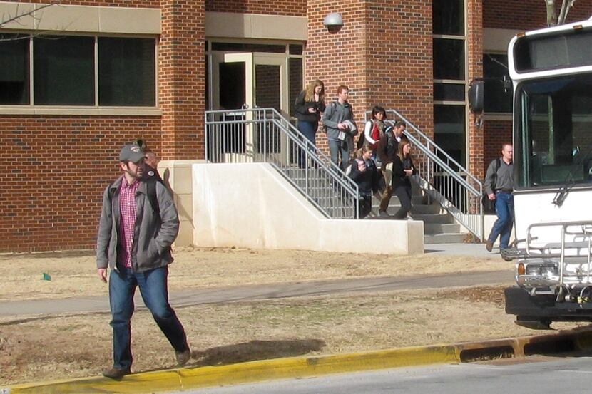 Students evacuate Gould Hall as Norman and University of Oklahoma police investigate a...