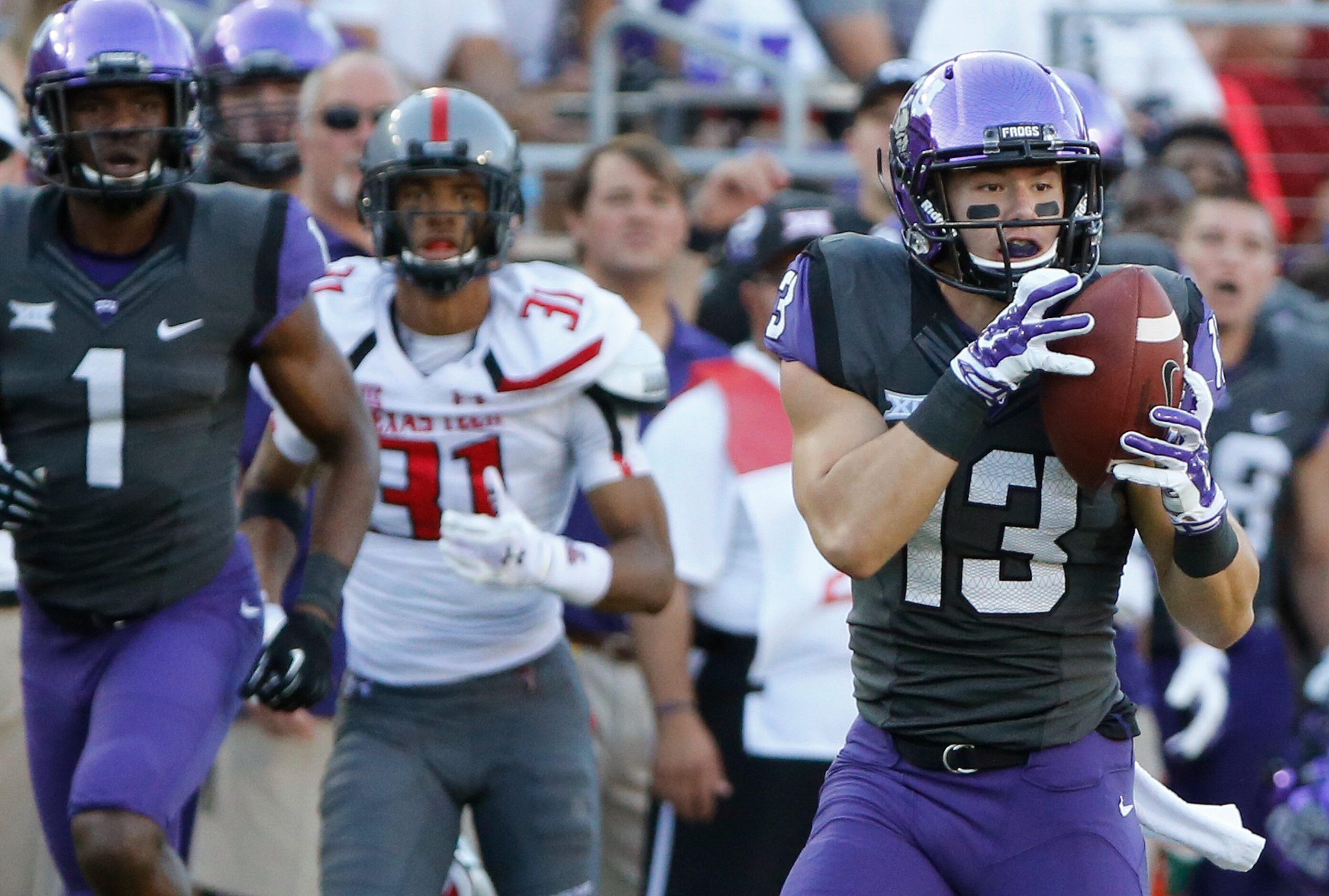 TCU receiver Ty Slanina (13) catches a third-quarter aerial and turns it into a touchdown as...