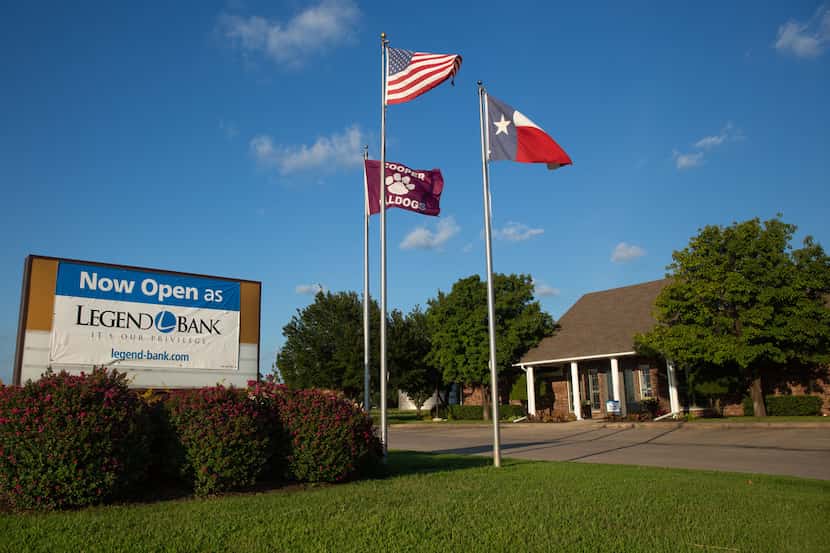 A new Legend Bank sign hangs over the former logo of the Enloe State Bank in Cooper, Texas,...