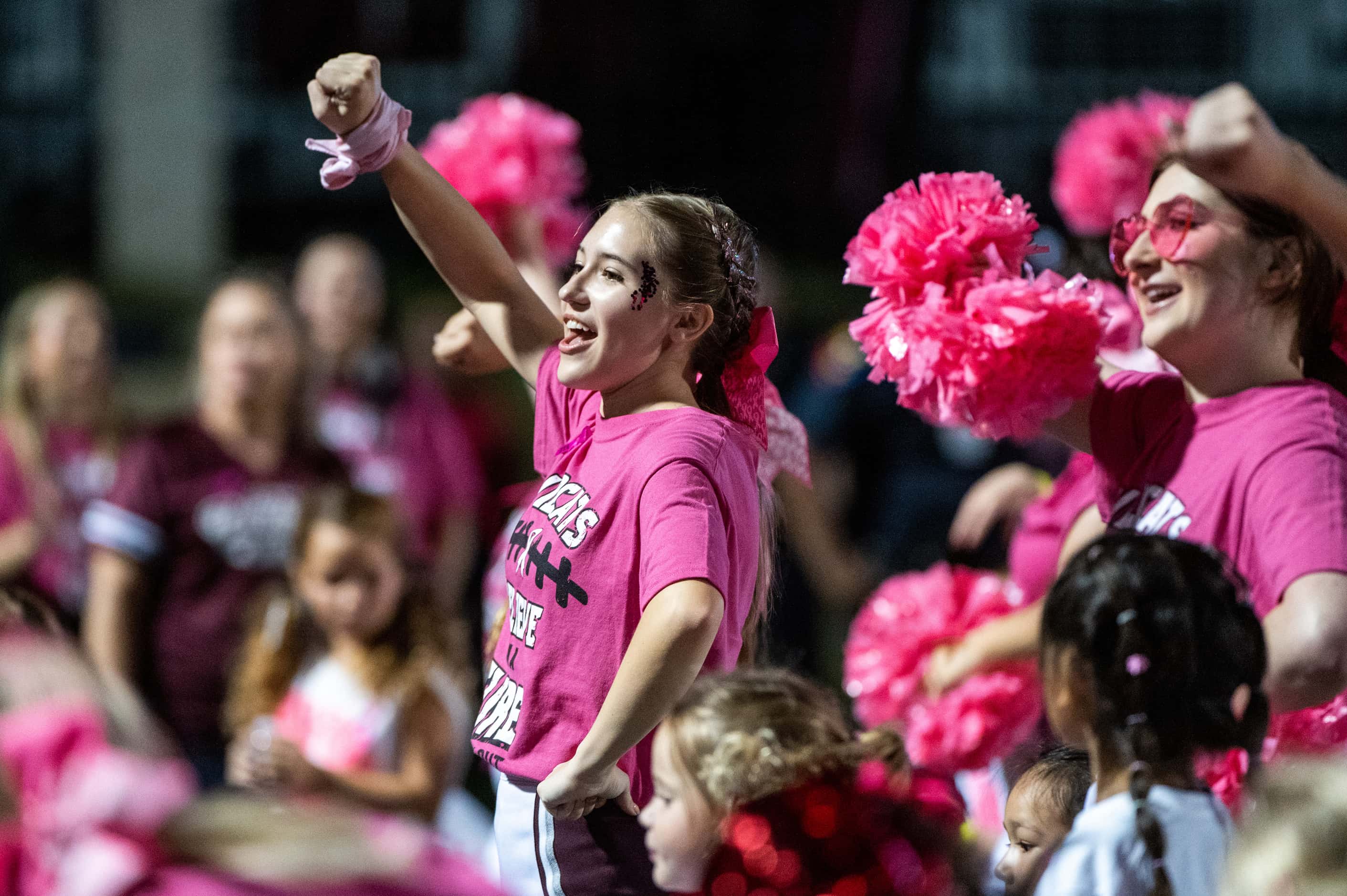 Plano cheerleaders perform with members of a youth spirit camp, in the first half during a...