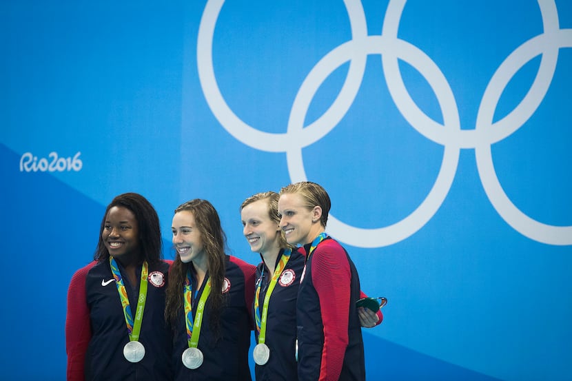 Team USA, from left, Simone Manuel, Abbey Weitzeil, Katie Ledecky and Dana Vollmer pose with...