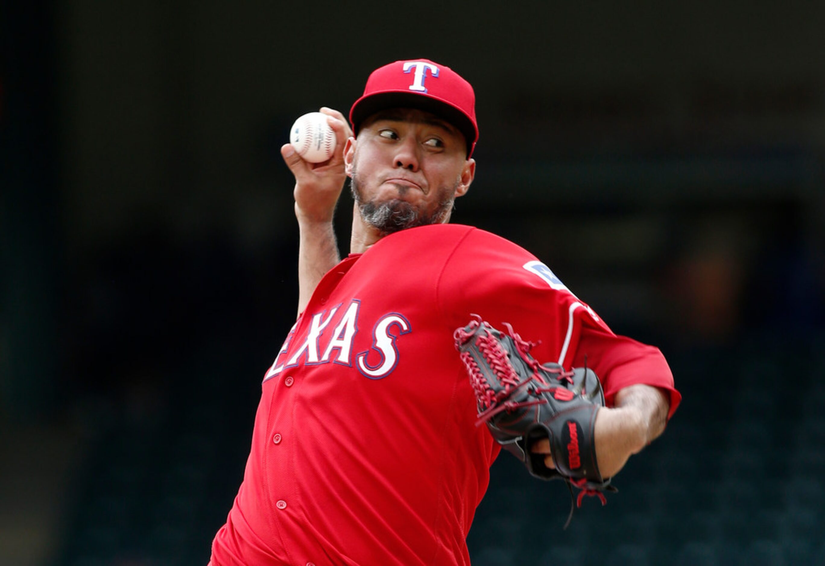 Texas Rangers starting pitcher Yovani Gallardo delivers against the Seattle Mariners during...