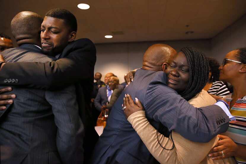 The parents of Jordan Edwards, Odell and Charmaine Edwards (facing camera), hug prosecutor...