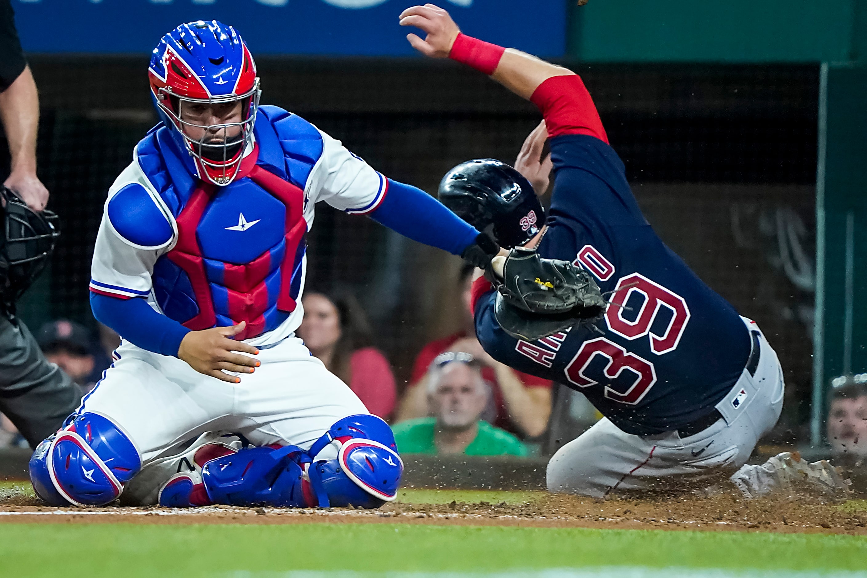 Boston Red Sox second baseman Christian Arroyo scores past the tag from Texas Rangers...