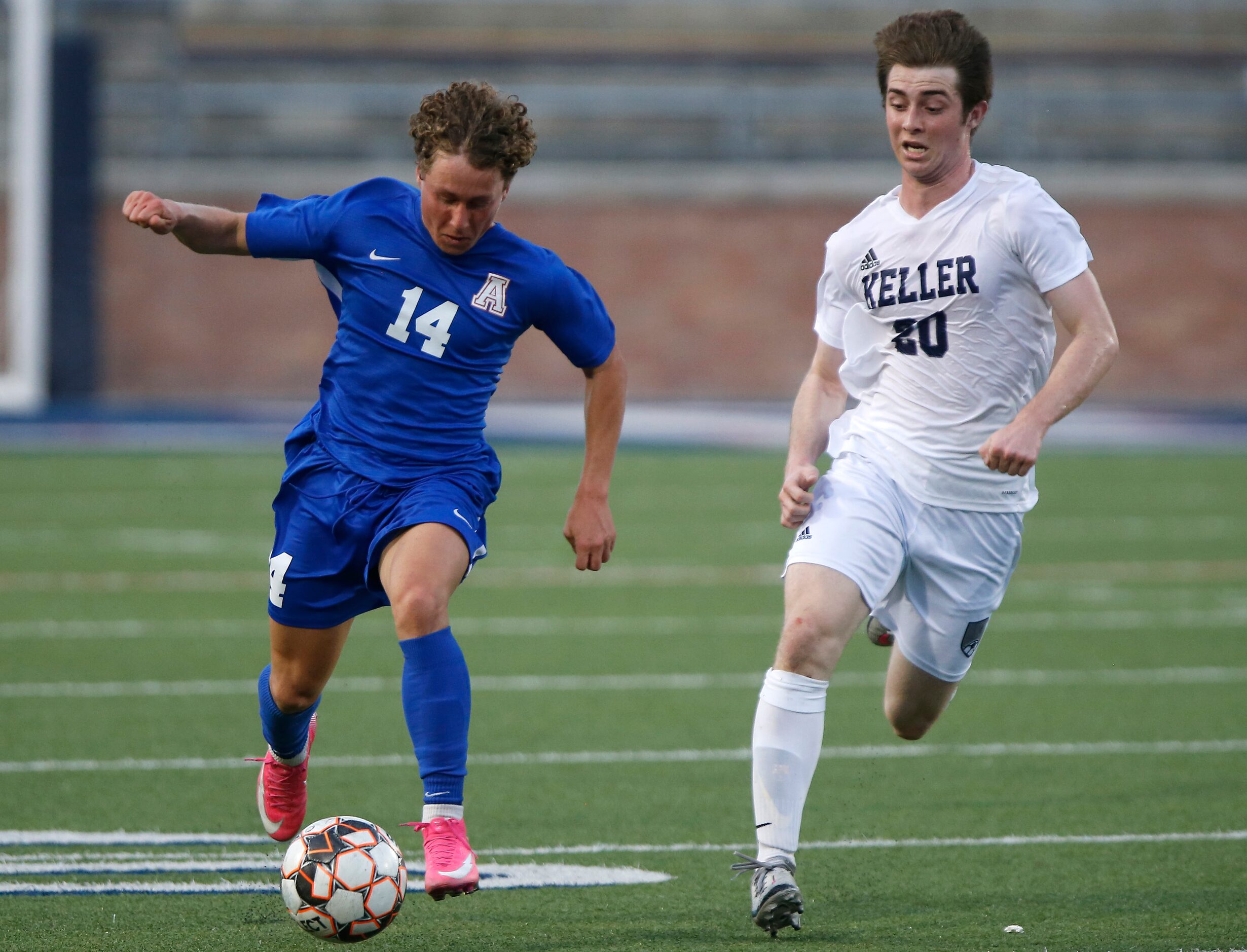 Allen forward Matthew Sanchez (14) brings the soccer ball up the field as he is defended by...