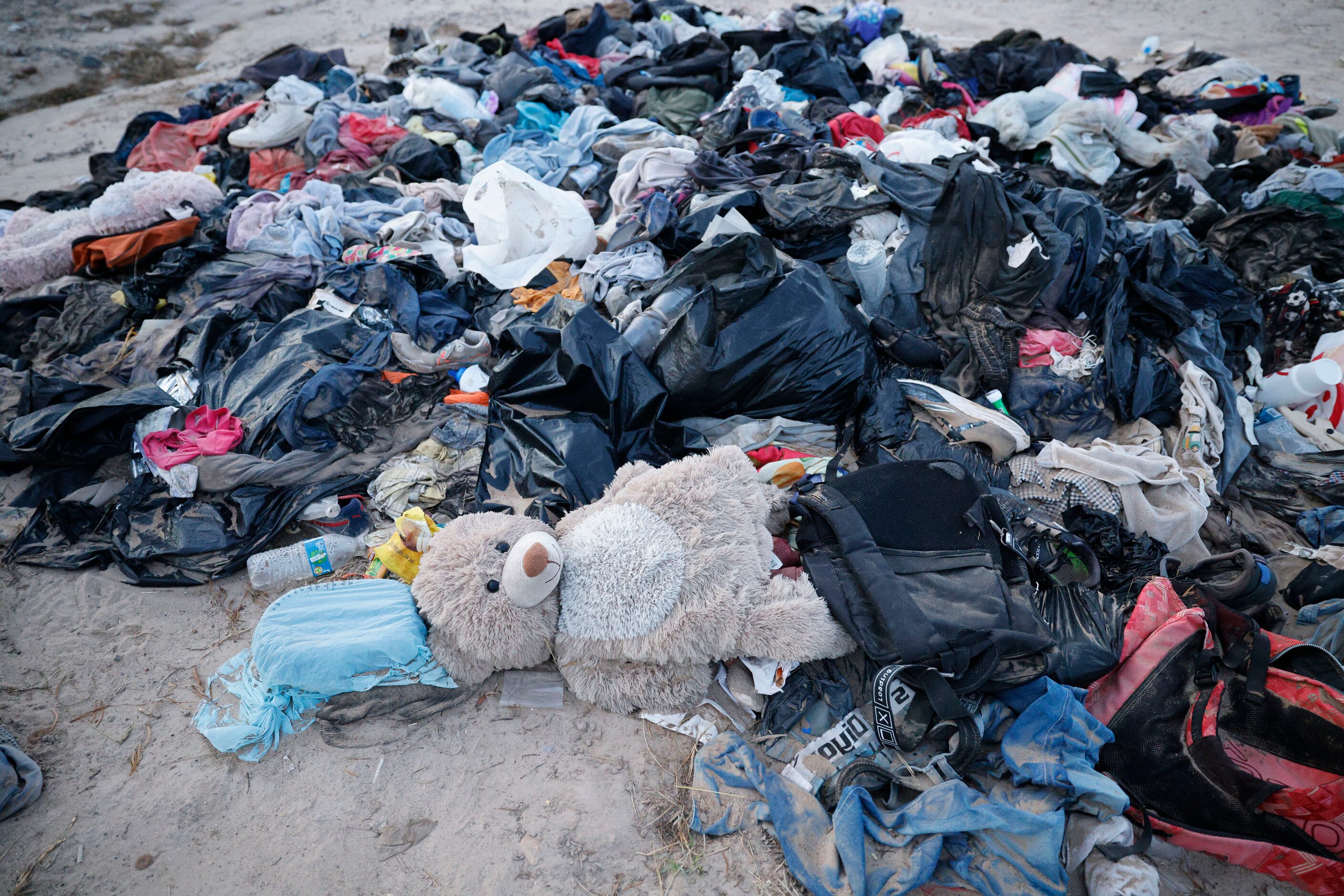 A teddy bear and clothes are seen near the Rio Grande, Wednesday, Jan. 31, 2024, in Eagle...