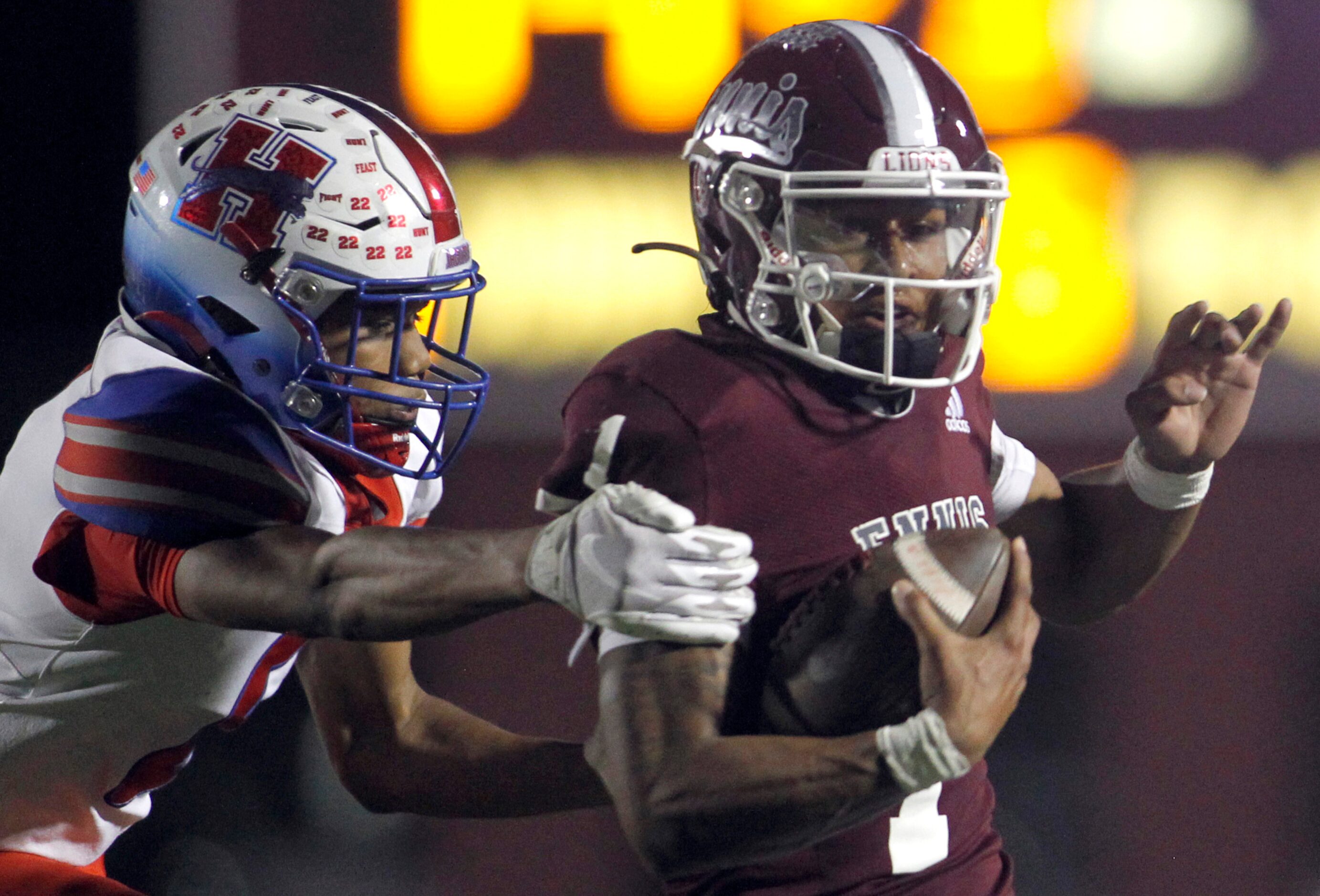 Ennis quarterback Gracen Harris (1), right, rushes for a first down before tackled by...