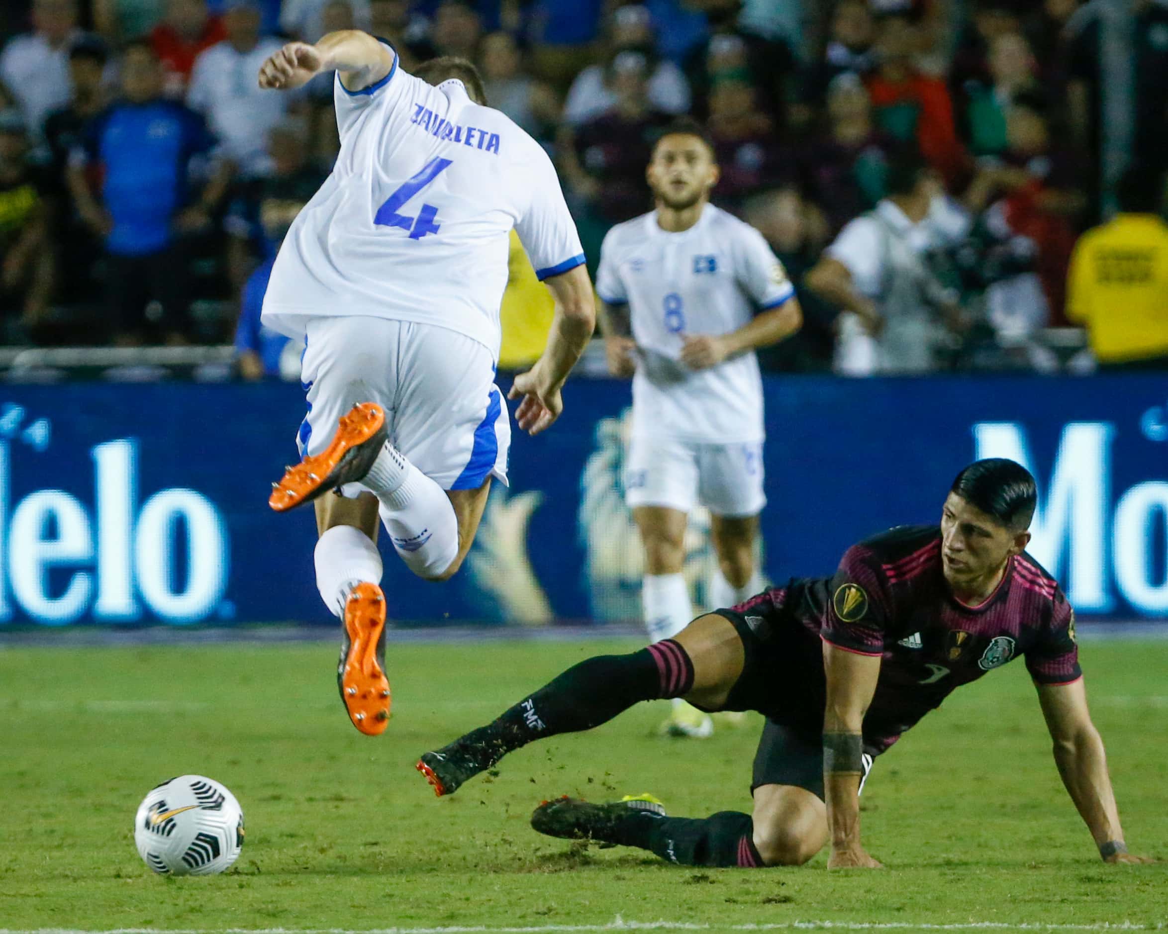 Mexico forward Alan Pulido (9) slides into El Salvador defender Eriq Zavaleta (4) during the...