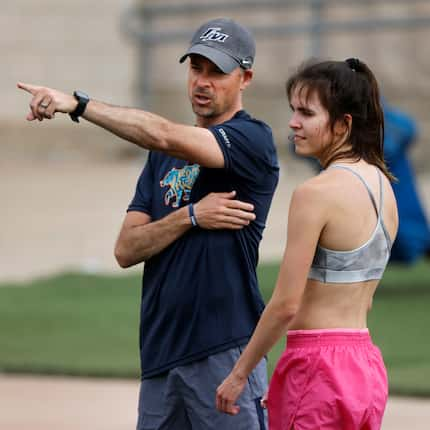 Flower Mound track coach Andrew Cook talks to his daughter, long distance runner Natalie...