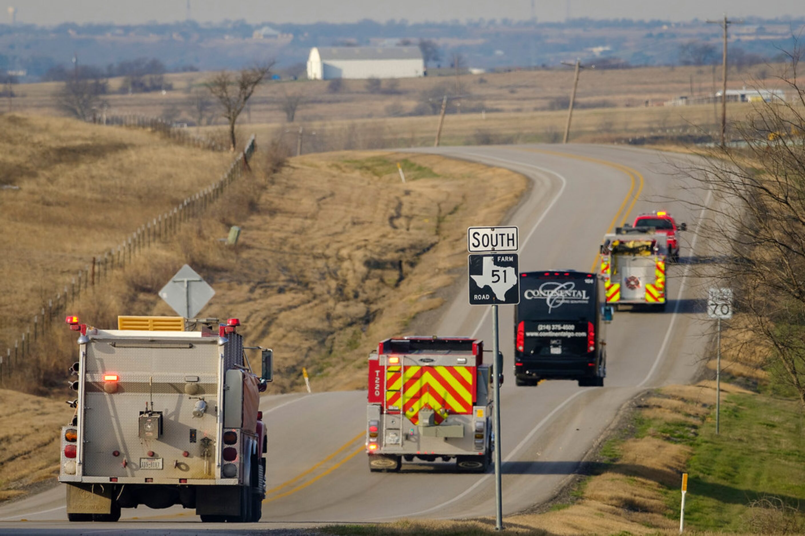 Vehicles from the Greenwood-Slidell Volunteer Fire Department escort the Slidell boy's...