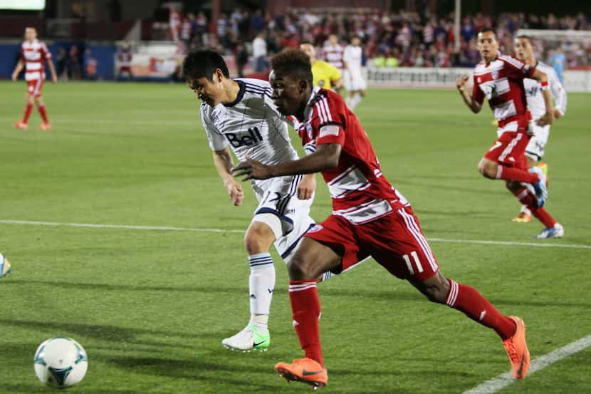 FC Dallas midfielder Fabian Castillo (11) moves the ball past Lee Young-Pyo (12) during a...