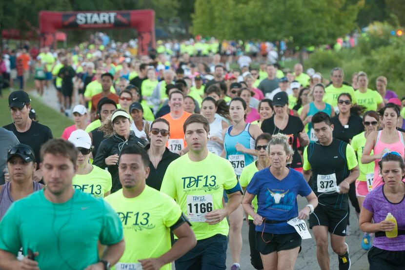 Runners begin the Tour des Fleurs 10K behind the Dallas Arboretum at White Rock Lake in 2013.