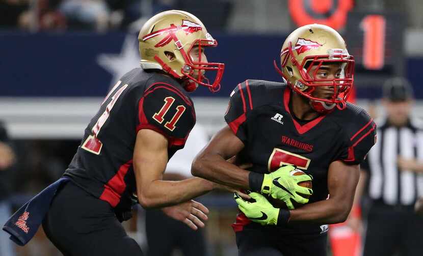 South Grand Prairie quarterback Greg Eisworth (11) hands the ball off to running back Andre...