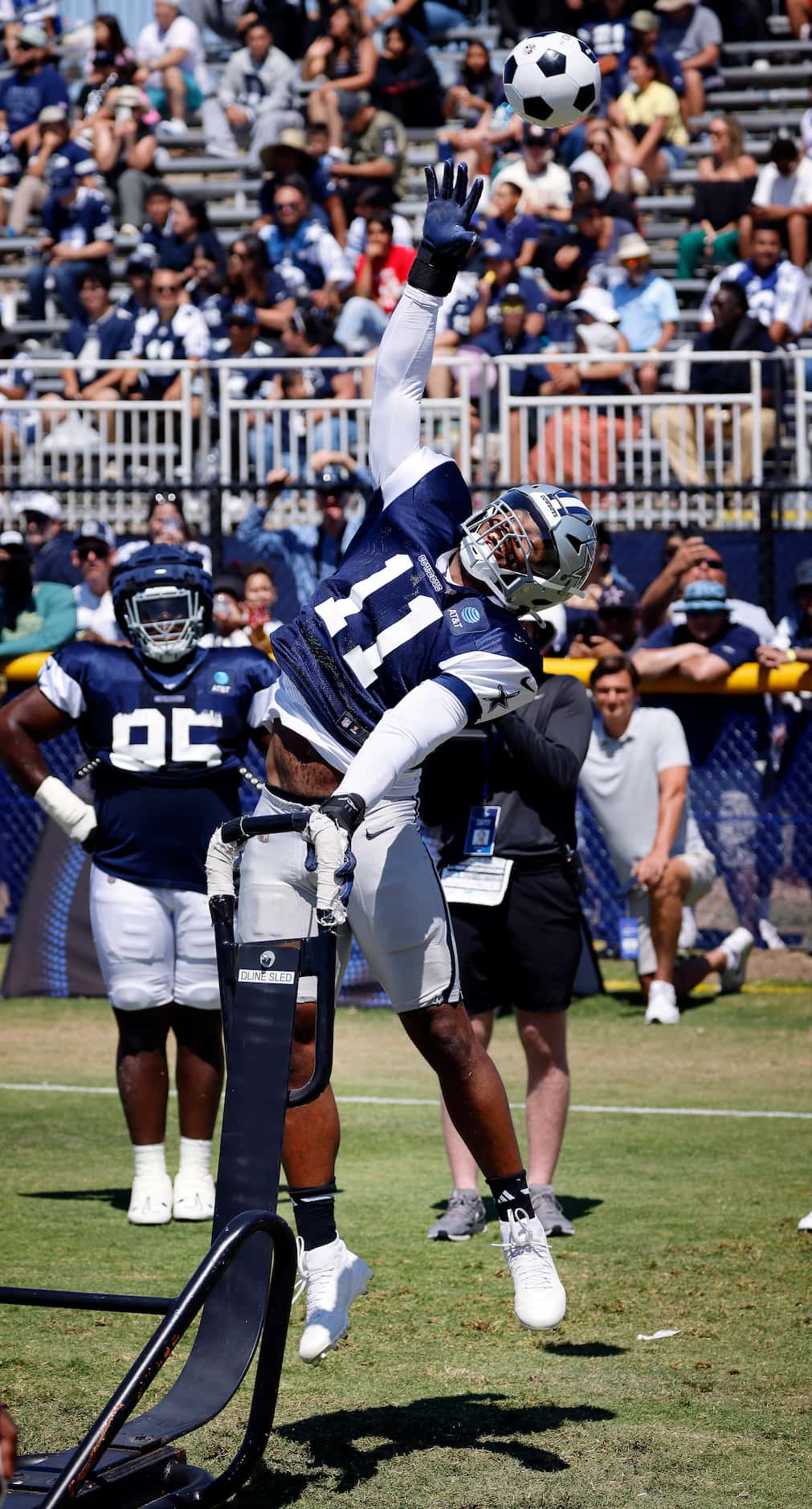 Dallas Cowboys linebacker Micah Parsons (11)  reaches to bat an overthrown soccer ball...