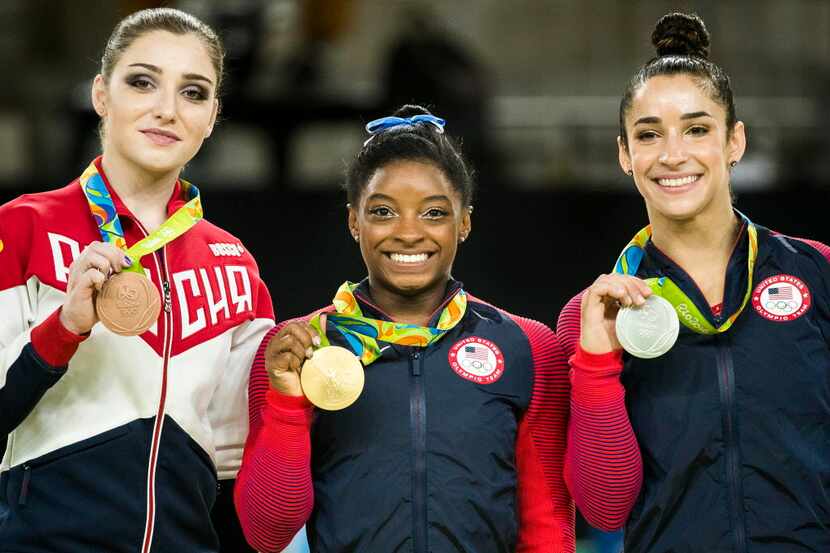 Bronze medalist Aliya Mustafina of Russia, gold medalist Simone Biles of the United States...