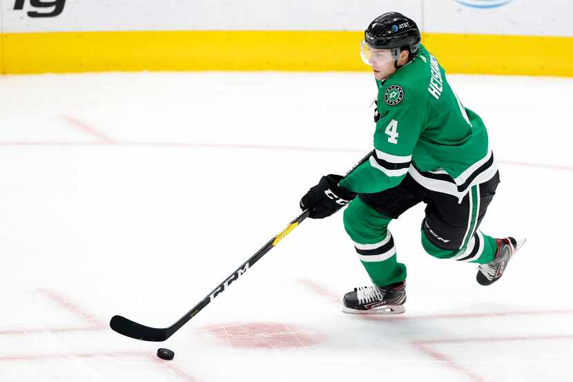 Dallas Stars defenseman Miro Heiskanen (4) brings the puck up ice against the Columbus Blue...