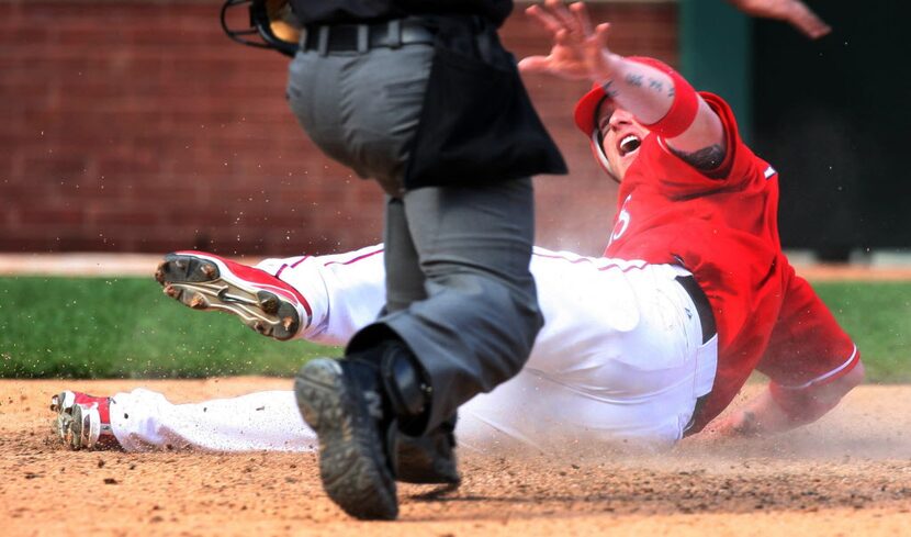 Texas Rangers player Hank Blalock is called safe at home by umpire Chris Guccione on a base...