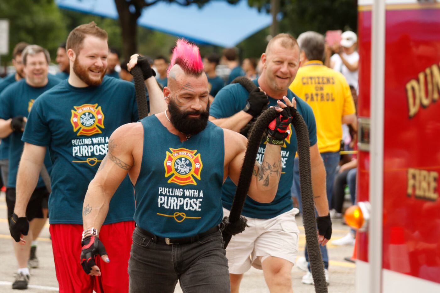 Chris Williams and the rest of the Fire Truck Pullin' Dudes carry the rope back to the...