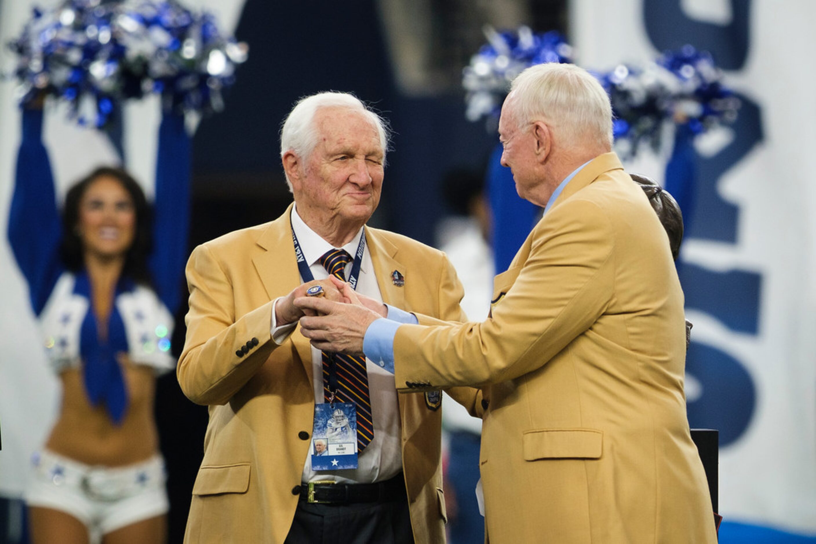 Gil Brandt is presented with his NFL Hall of Fame ring by Jerry Jones during halftime of an...